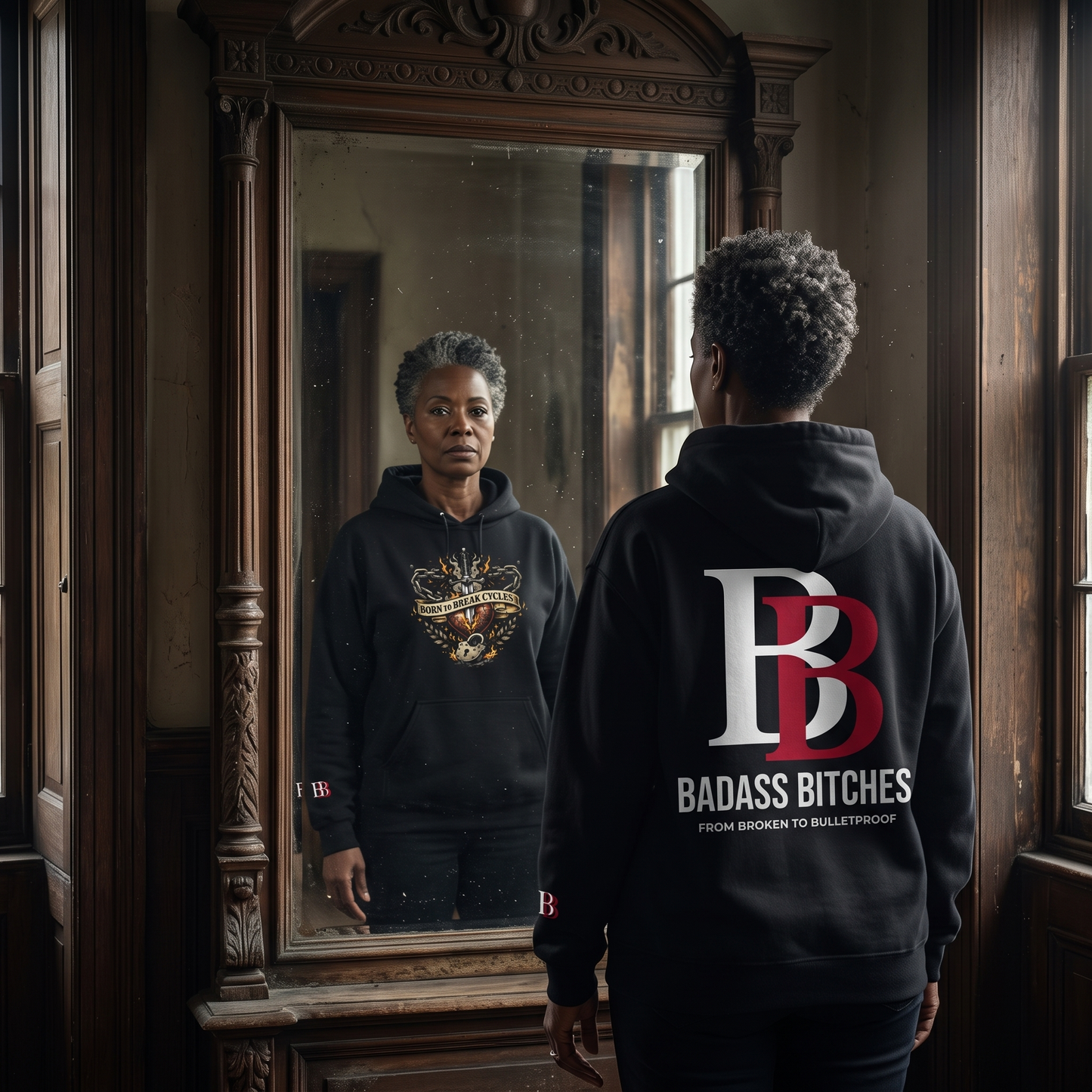 Women wearing a Born To Break Cycles hoodie with 'Badass Bitches' logo, standing in front of a mirror.