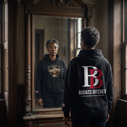 Women wearing a Born To Break Cycles hoodie with 'Badass Bitches' logo, standing in front of a mirror.