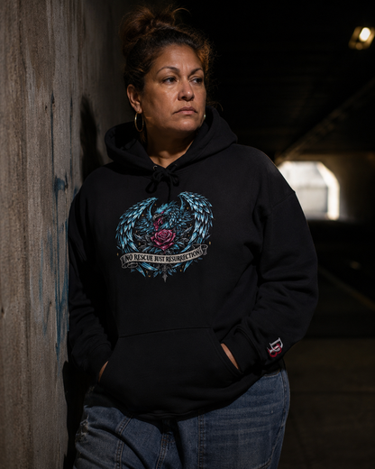 Women wearing a No Rescue Just Resurrection black hoodie with a graphic design, standing against a dark wall.