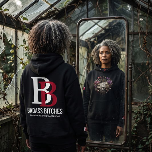 Women wearing a Not Lucky Just Unbreakable hoodie with 'Badass Bitches' logo in a greenhouse setting