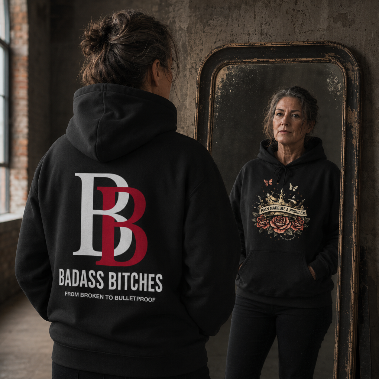 Women wearing a "Pain Made Me A Problem" black hoodie with 'Badass Bitches' logo, standing in front of a mirror.
