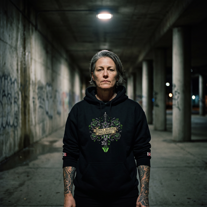 Women wearing a Rebuilt Reloaded Unreachable black hoodie with a graphic design in an urban setting with graffiti.