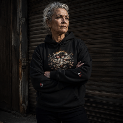 Women wearing a Starting Over Doesn't Mean You're Broken black hoodie with a graphic design, standing against a dark background.