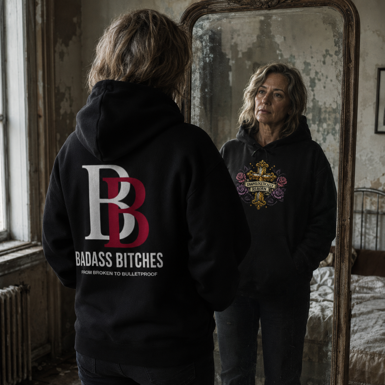 Black empowerment hoodie featuring "UNAPOLOGETICALLY REBORN" artwork on the front and Badass Bitches BB logo with "FROM BROKEN TO BULLETPROOF" branding on the back.