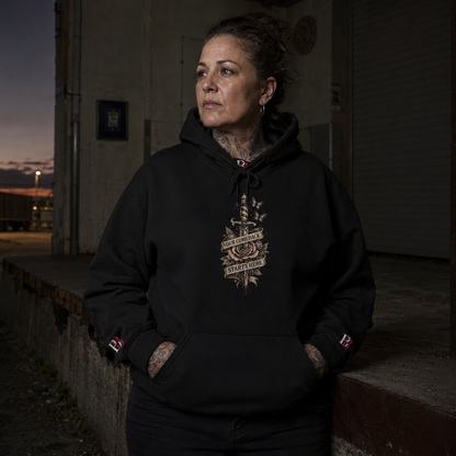 Person wearing a "Your Comeback Starts Here" black hoodie with a "Badass Bitches" logo, standing against a dark background.