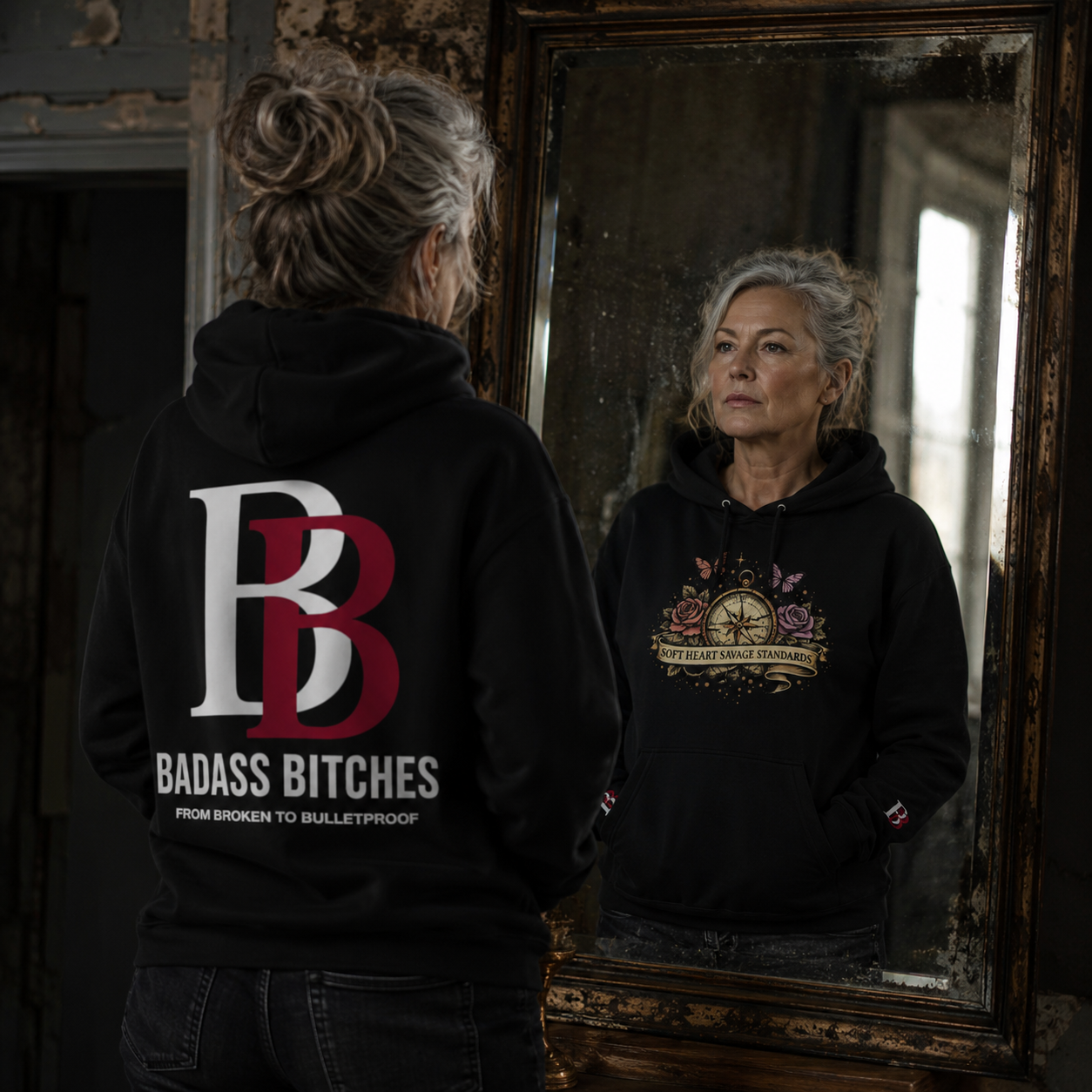 Black empowerment hoodie featuring "SOFT HEART SAVAGE STANDARDS" artwork on the front and Badass Bitches BB logo with "FROM BROKEN TO BULLETPROOF" branding on the back.
